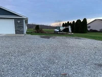 Newly installed gravel driveway with crushed stone surface and proper grading
