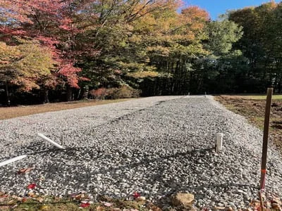 Completed gravel driveway with compacted stone base and clean edges